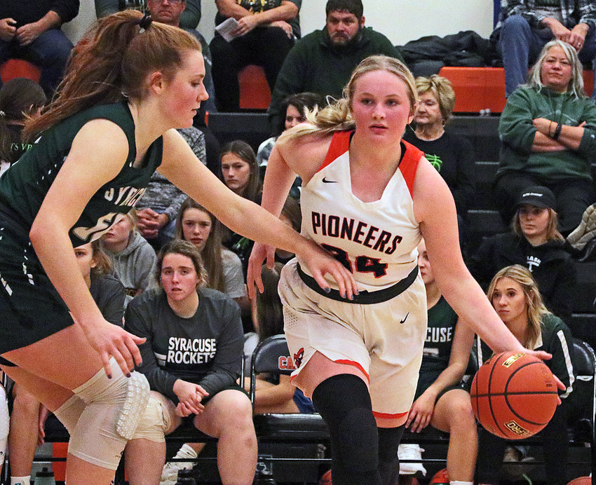 Pioneers sophomore Raegen Wells, right, dribbles while defended by Syracuse's Lily Vollertsen on Saturday at Fort Calhoun High School.