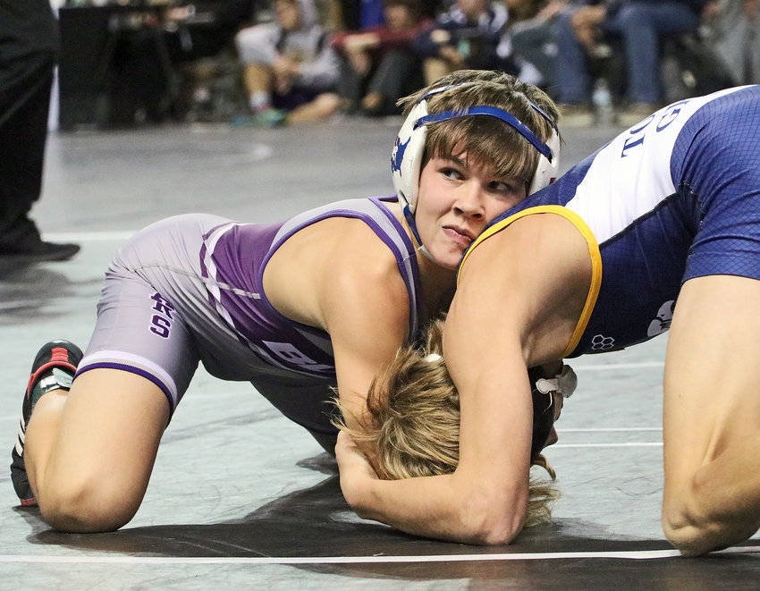 Blair 106-pounder Hudson Loges, left, looks to the clock while wrestling Austin Herbst of Totino-Grace on Friday in Council Bluffs.