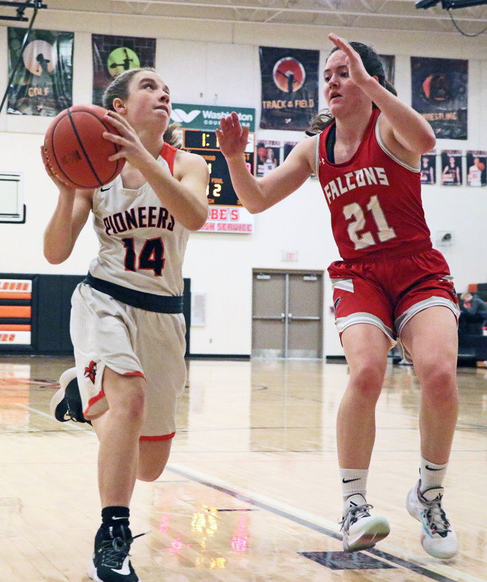 Pioneers freshman Kaylee Taylor, left, looks to the rim as Douglas County West's Grace Holm defends Thursday at Fort Calhoun High School.