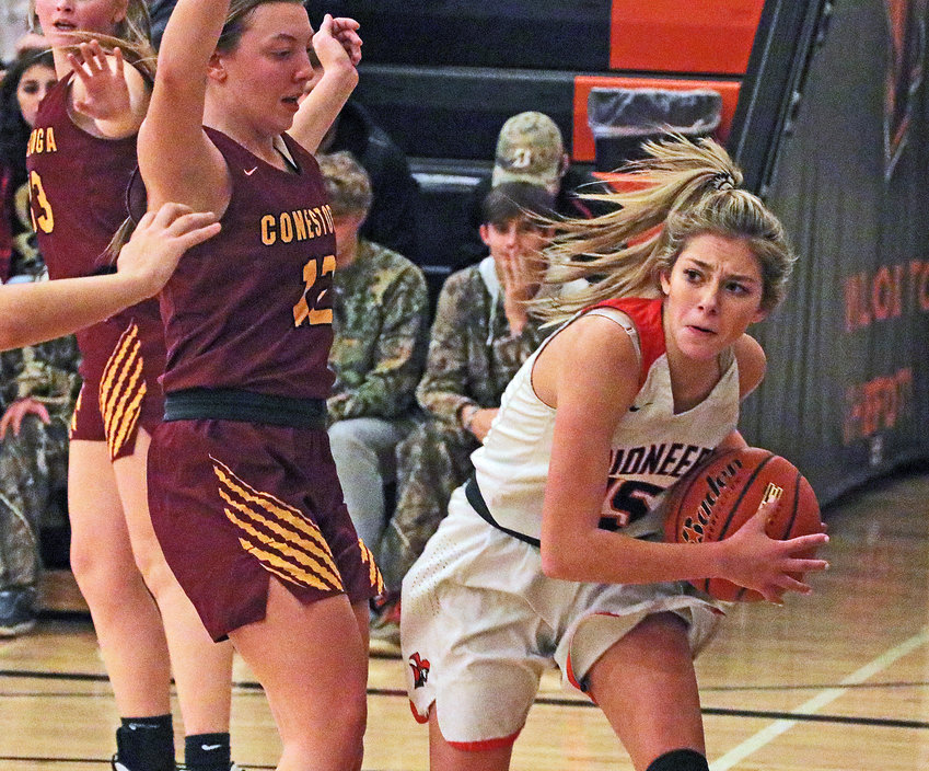 Pioneers senior Tess Skelton, right, looks for a way around the Conestoga defense Monday at Fort Calhoun High School.