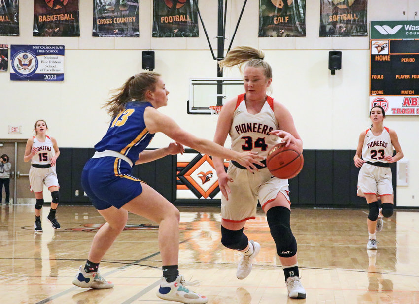 Pioneers sophomore Raegen Wells, middle right, dribbles around Logan View's Rebekka Jay on Thursday at Fort Calhoun High School.