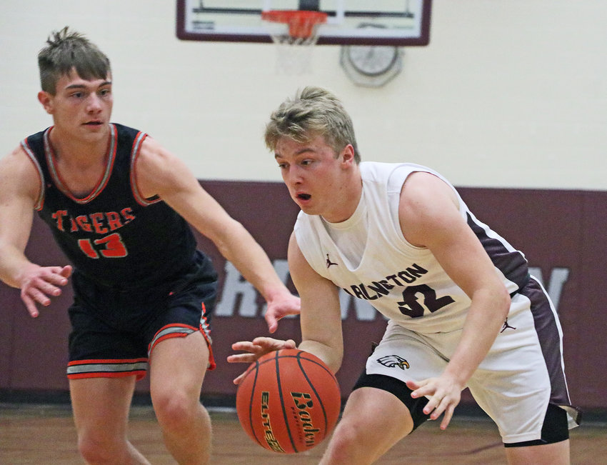 Eagles senior Isaac Foust, right, drives to the hoop as North Bend's Zac Pospisil defends Tuesday at Arlington High School.