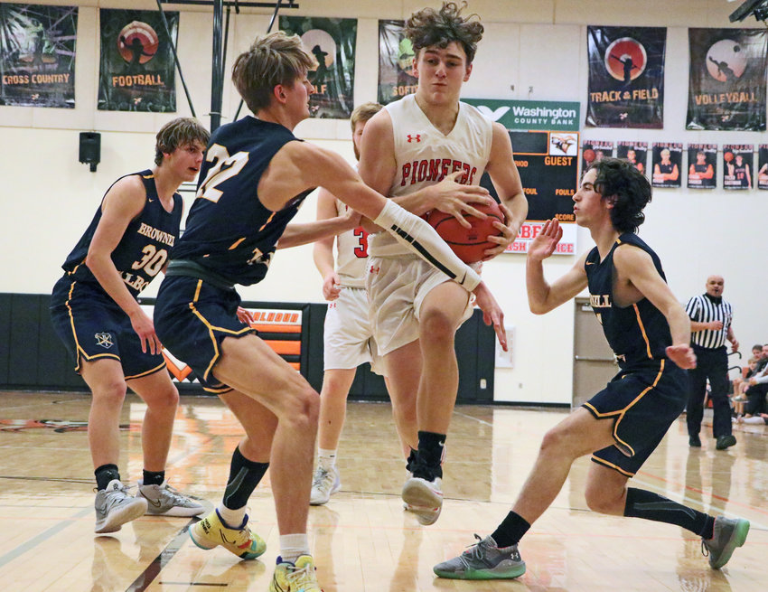Pioneers junior Glenn Hunter, middle, drives through a congested lane against Brownell-Talbot on Tuesday at Fort Calhoun High School.