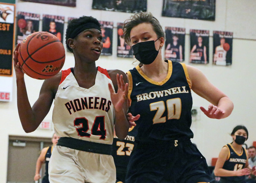 Pioneers guard Dala Drowne, left, starts her way up to the hoop as Brownell-Talbot's Molly Clark defends Tuesday at Fort Calhoun High School.