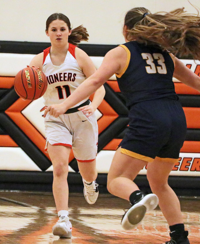 Pioneers guard Maddy Tinkham, left, dribbles up the floor as Brownell-Talbot's Paige Birch defends Tuesday at Fort Calhoun High School.