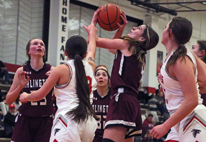 Arlington junior Keelianne Green, middle, shoots and is fouled by the Falcons' Ellesia Guardipee on Friday at DC West.