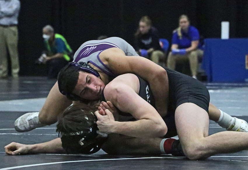 Blair 152-pounder Yoan Camejo, top, controls his match with Minden's Evan Smith on Saturday at the Buffalo County Fairgrounds.