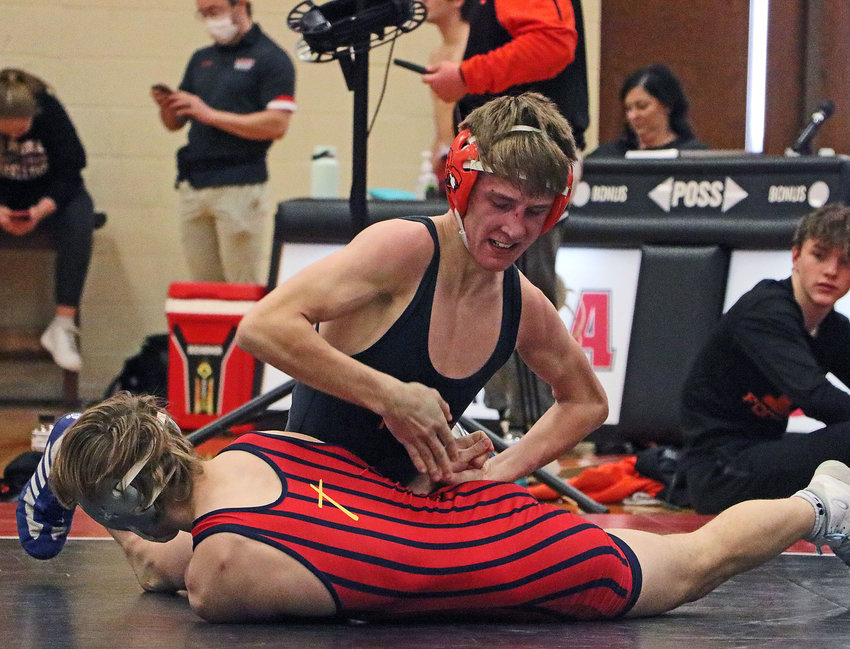 Fort Calhoun 126-pounder Ely Olberding, top, works to turn DC West/Concordia wrestler Jack Hartman on Saturday during the Class B District 2 Tournament in Aurora. Olberding and his brother Lance each qualified for a third time during the event.