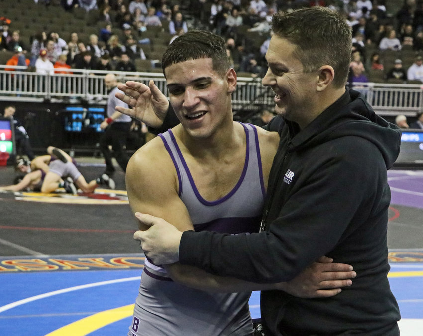Blair wrestling coach Erich Warner, right, congratulates Yoan Camejo after his 152-pound quarterfianls victory Thursday in Omaha.