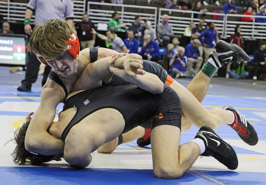 Fort Calhoun 132-pounder Lance Olberding, top, works to turn Cole Stokey of Ogallala on Thursday in Omaha.