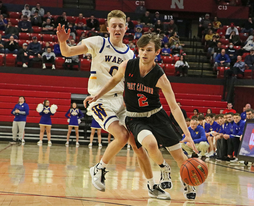 Fort Calhoun senior Owen Newbold, right, dribbles past Wahoo's Marcus Glock on Tuesday in Lincoln.