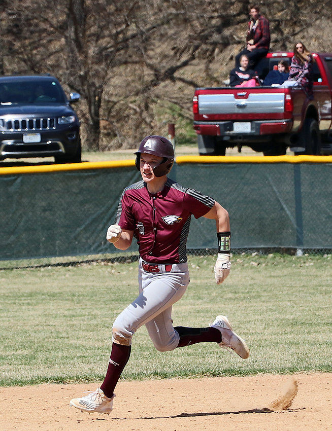 Arlington's Trevor Denker races from second to third base Saturday at the Washington County Fairgrounds.