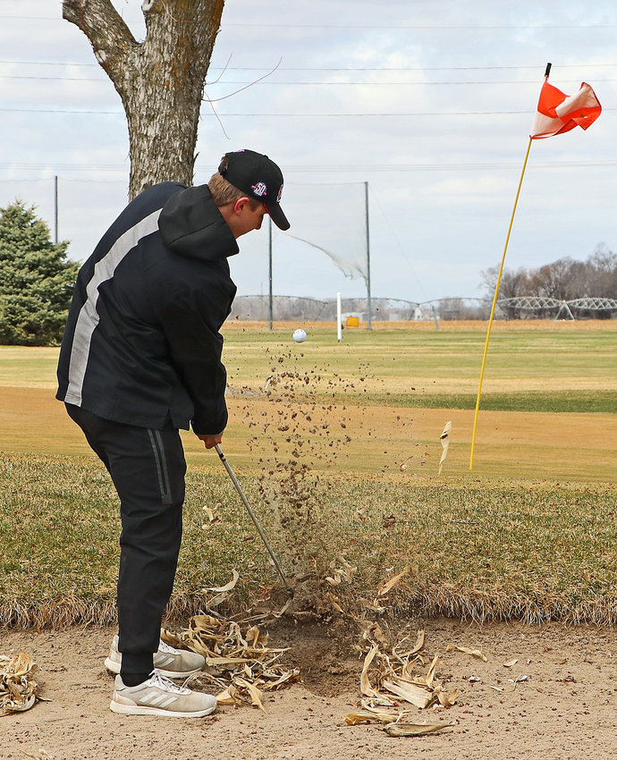 Fort Calhoun's Dylan Boldt hits his ball out of the bunker and onto the green Wednesday at The Pines in Valley.