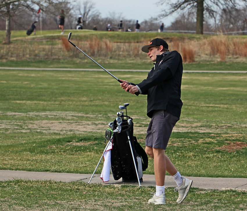 Fort Calhoun's Owen Miller watches his approach shot Monday at Ashland Golf Club.