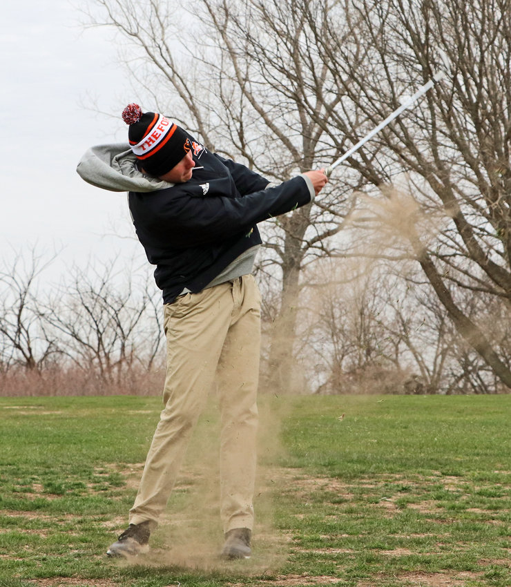 Fort Calhoun's Landon Miller stirs up some dirt on his shot Tuesday at River Wilds Golf Club.