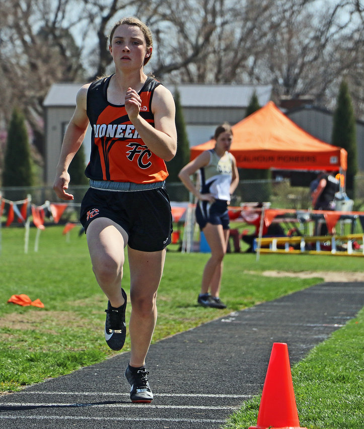 The Pioneers' Kaylee Taylor races down the triple jump runway Tuesday at Fort Calhoun High School.