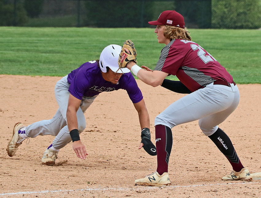 Blair's J'Shawn Unger, left, lunges back to first base as Arlington's Nick Smith waits on the throw to the bag Friday in Waverly.