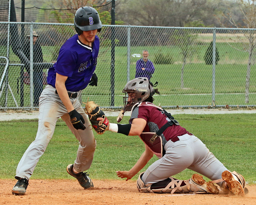 Arlington catcher Braden Monke, right, tags out Blair's Conner O'Neil at home plate Friday in Waverly.