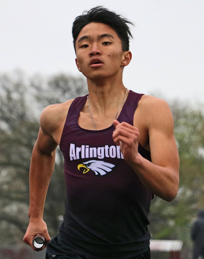 The Eagles' Dillon Kim races to the line in the 1,600-meter relay Thursday at Arlington High School.