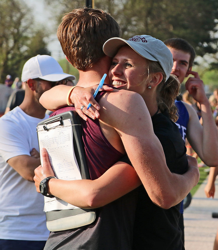 Arlington assistant coach Michaela Curran embraces Colby Grefe after the Eagle qualified for the state meet Tuesday in Columbus.