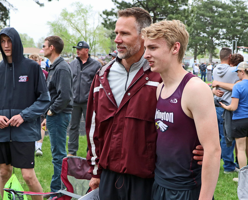 Arlington's Kaden Foust, right, poses for a photo with coach Steven Gubbels after winning the long jump Tuesday in Columbus.