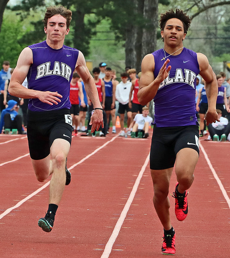 Blair sprinters Zach Lindau, left, and Ethan Baessler race side-by-side Tuesday in Columbus.