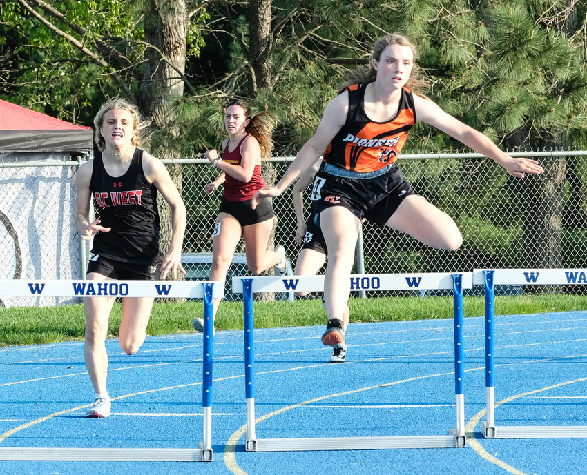 Fort Calhoun freshman Kaylee Taylor, right, competes in the 300-meter hurdles Tuesday at Wahoo High School.