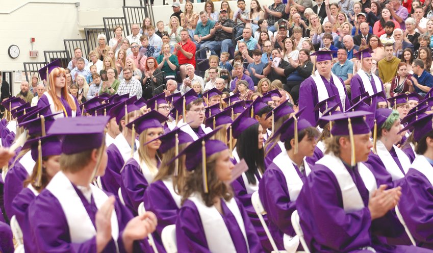 The crowd and students applaud to recognize members of the Class of 2022 who will join the United States Military after graduation. Those three students are, standing, from left, Dailynn Luttig, Camron Larsen and Dalton Nielsen.