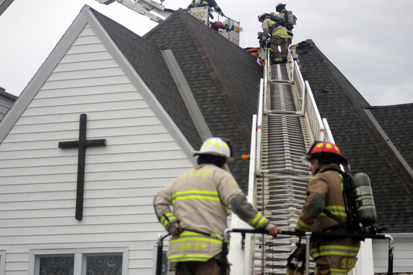 Connie Green, First Baptist Church secretary, was working when she heard a lighting strike, at which time she stepped outside and saw smoke and eventually flames coming from the older part of the building Tuesday afternoon.