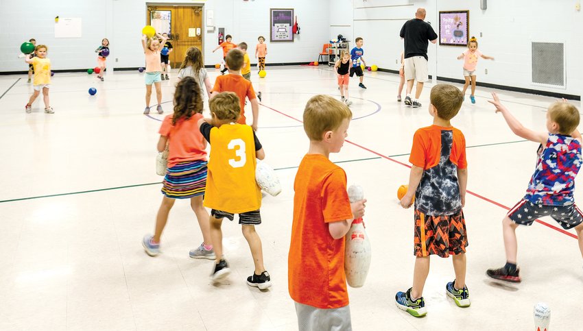 Students play pin knock down at North School during Fun Days.