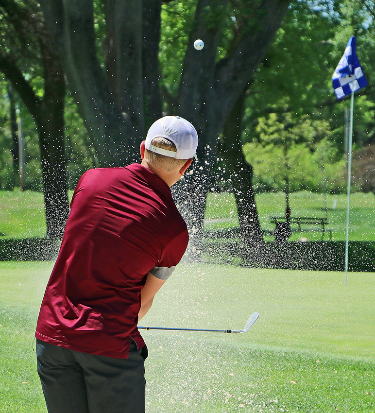 Arlington's Stokely Lewis chips his ball out of the bunker Monday at Fremont Golf Club.