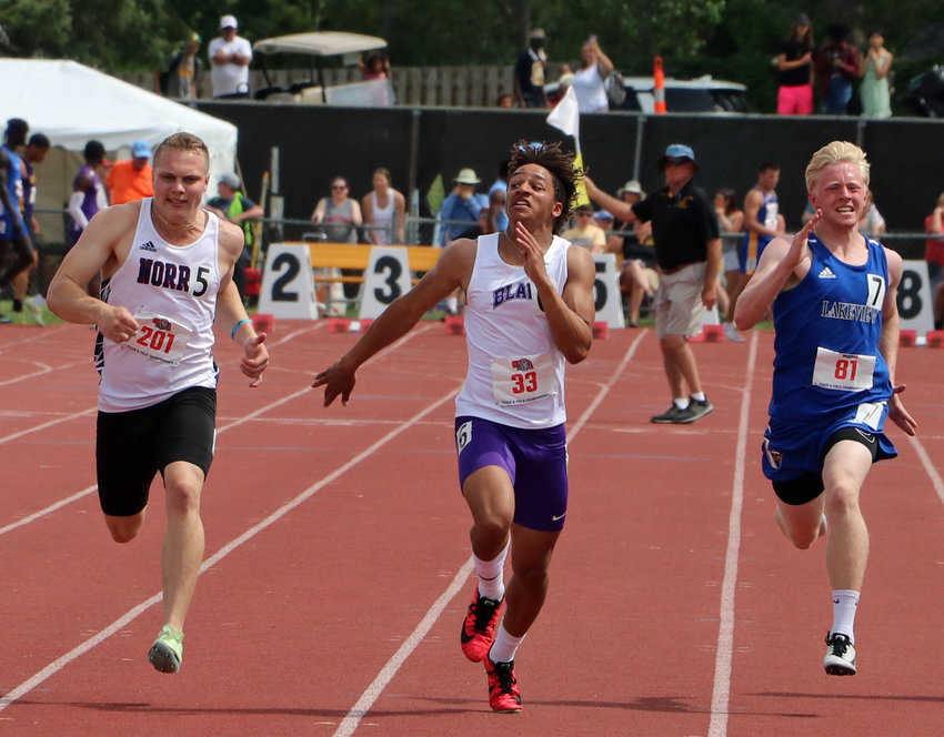 Blair sophomore Ethan Baessler, middle, stretches to the finish line Thursday at Omaha Burke Stadium.