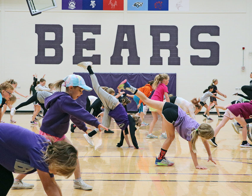 Youngsters stretch before Wednesday's start to the Blair Softball Youth Camp at BHS.