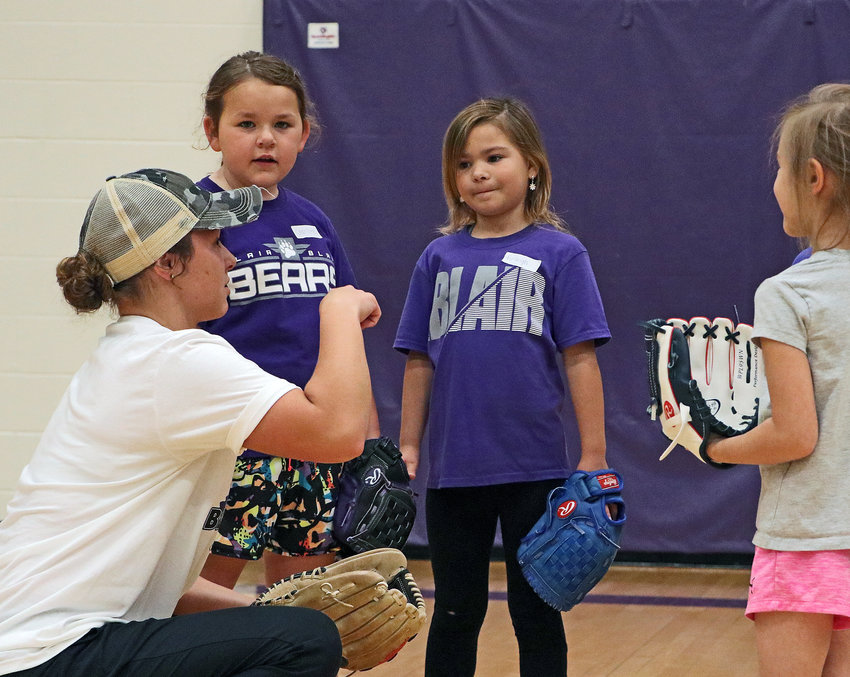 Young campers listen to instructions from high school softball player Cailey Anderson on Wednesay at BHS.