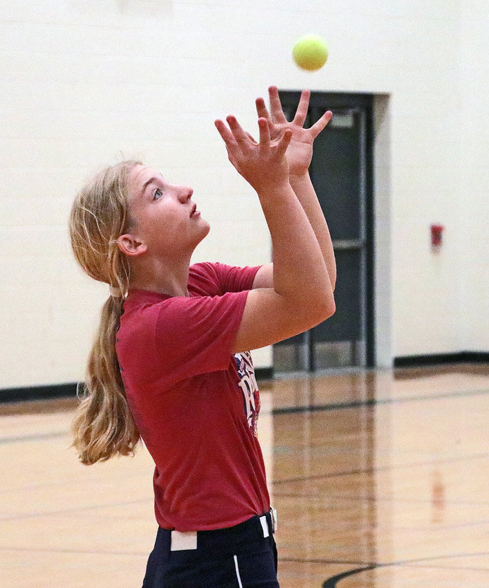 Amiah Dirkschneider catches a tennis ball during a drill Wednesday at Blair High School.