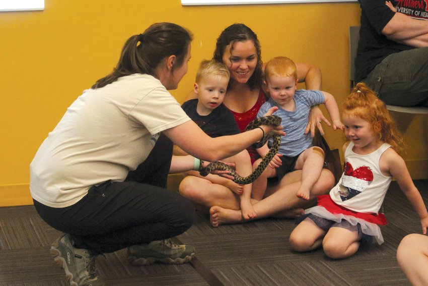 Natural resources educator Kaylyn Kelley gives children an up-close look at a fox snake during an Animal Adaptations presentation at the Blair Public Library and Technology Center on June 7.
