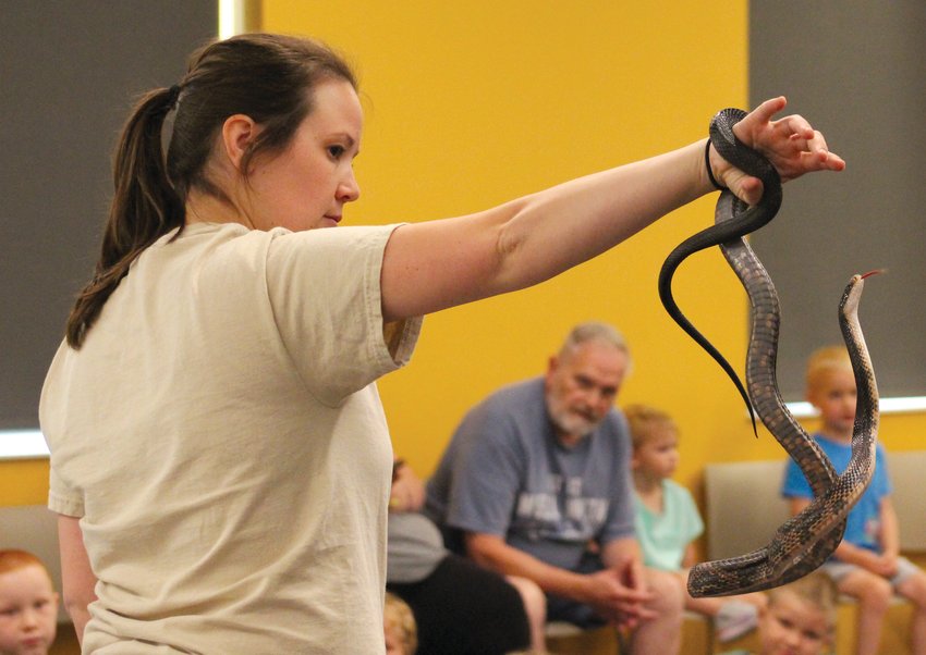 Papio-Missouri River Natural Resources District natural resource educator Kaylyn Kelley lets a rat snake take a closer look at the crowd.