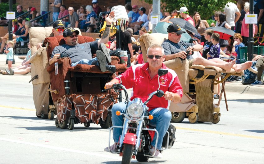 Riding mini cycles and recliners, Shriners roll along Washington Street during the Gateway to the West Days.