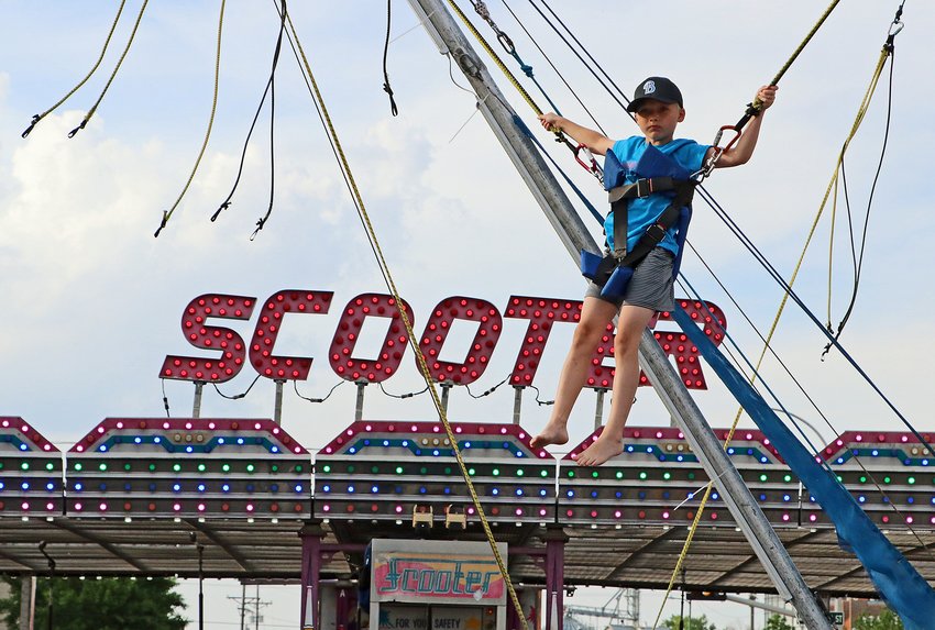 Finn Miller, 9, of Blair gains some height Friday during the Gateway to the West Days carnival.