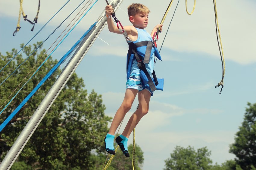 Taylor Corbett, 9, bungees at the Merriam's Midway Carnival Saturday during Gateway to the West Days.