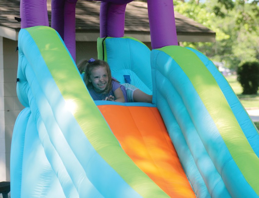 Isabelle Johnson, 5, excitedly reaches the top of a slide during Reach Church's Family Night at Lions Park Sunday evening during Gateway to the West Days.
