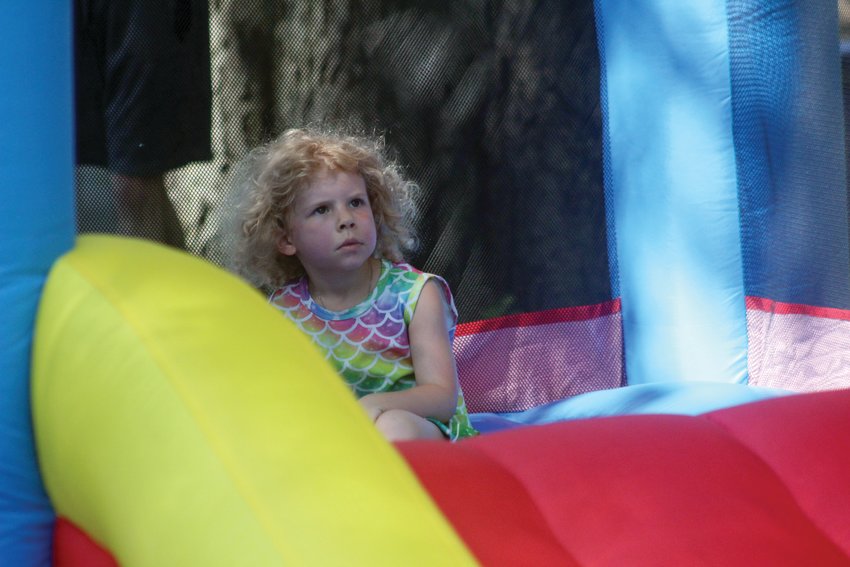 Abigail Norton rests after a jump Sunday evening at Reach Church's Family Night at Lions Park during Gateway to the West Days.