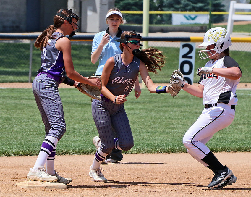 Blair Chaos infielder Elinn Bosanek, middle, reaches to tag a Nebraska Froce Elite base runner out Saturday at the Blair Youth Sports Complex.