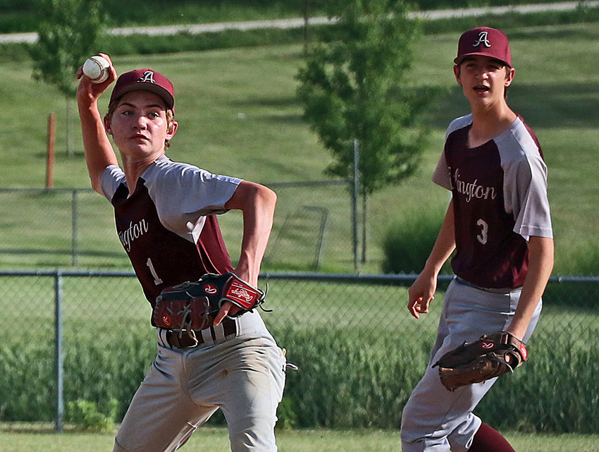 Arlington infielder Luke Sharp, left, throws to first base for an out as Jackson Stosich lends support Tuesday at the Two Rivers Sports Complex.
