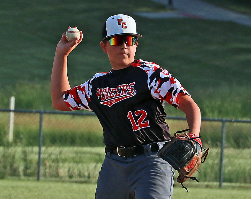 Beau Ruma of the Fort Calhoun age 14 and younger baseball team throws the ball to first base for an out Tuesday at the Two Rivers Sports Complex. The Pioneers fell to the Eagles, 14-6.