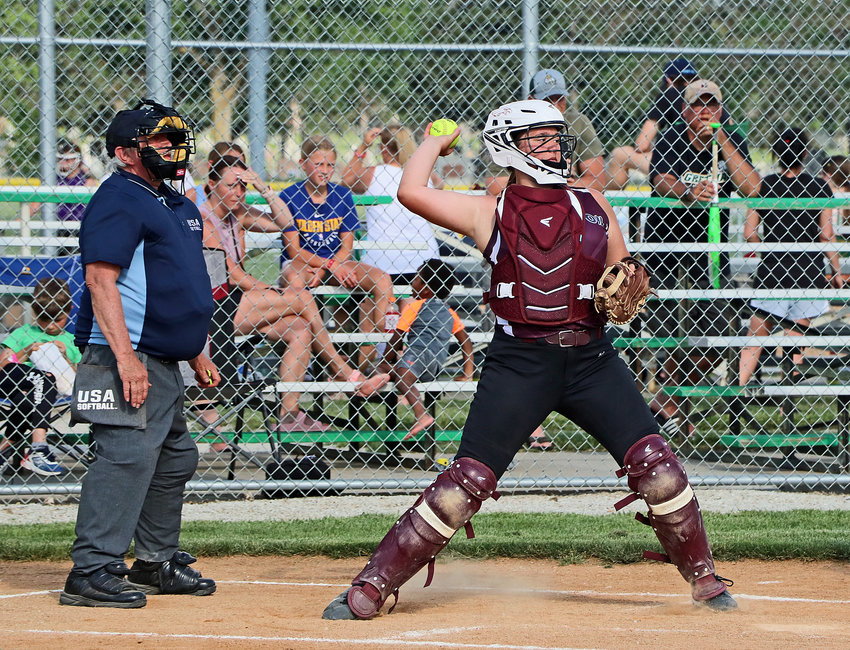 Arlington age 12 and younger catcher Hayley Arp tries to catch a base runner stealing with a throw to second base June 10 at the Blair Youth Sports Complex.