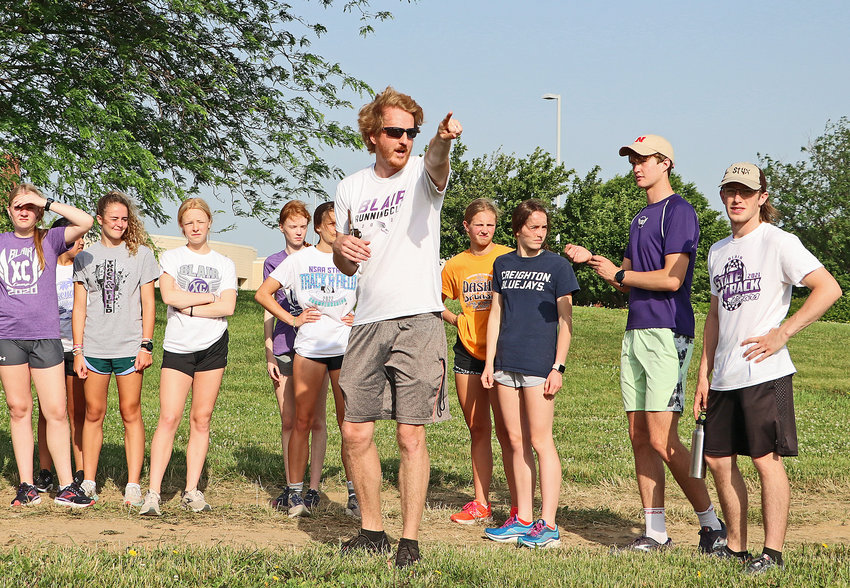 New Blair head coach Carson Norine, middle, points out an 800-meter cross-country course Tuesday near Otte Blair Middle School.