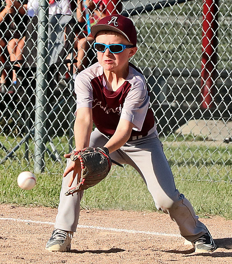 Micah Kuester of the Arlington 8U team tries to nab a throw to first base June 2 at the Two Rivers Sports Complex.