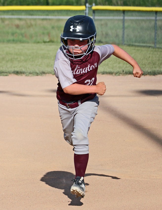 Arlington 10U baseball player Corbin Wagner runs back to the dugout June 2 at the Two Rivers Sports Complex.