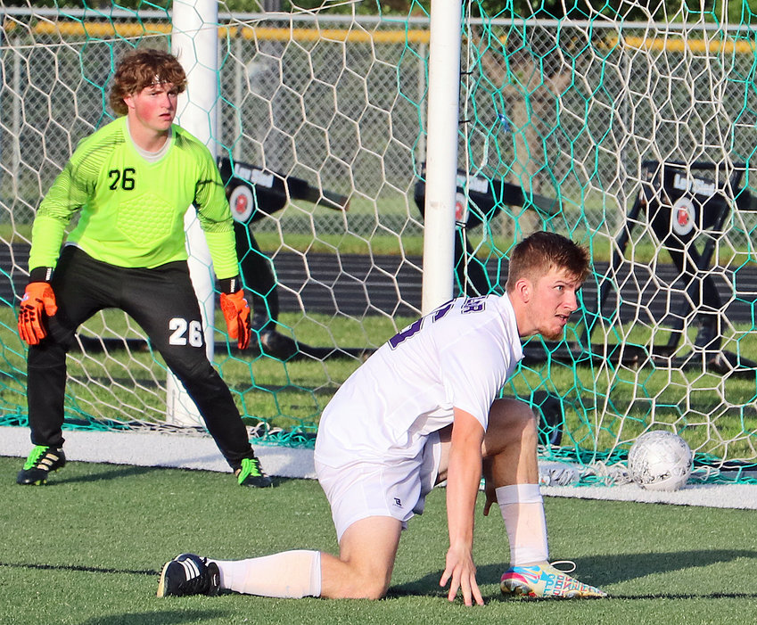 Blair's Tyler Schroder, right, gets low on defense in front of goalkeeper Chase Heck of Grand Island Northwest on Friday at Omaha Skutt.